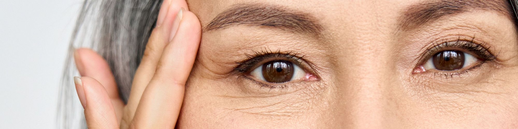 Mature lady with wrinkles around eye area